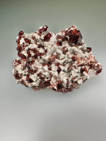 Spessertine and Albite on Muscovite, Tongbei, Fujian Province, China, Mined c. early 2000s, ex. WIlliam Mickols Collection WEM591, Small Cabinet, 1.3 x 6 x 8 cm, $450. Online Oct. 9.